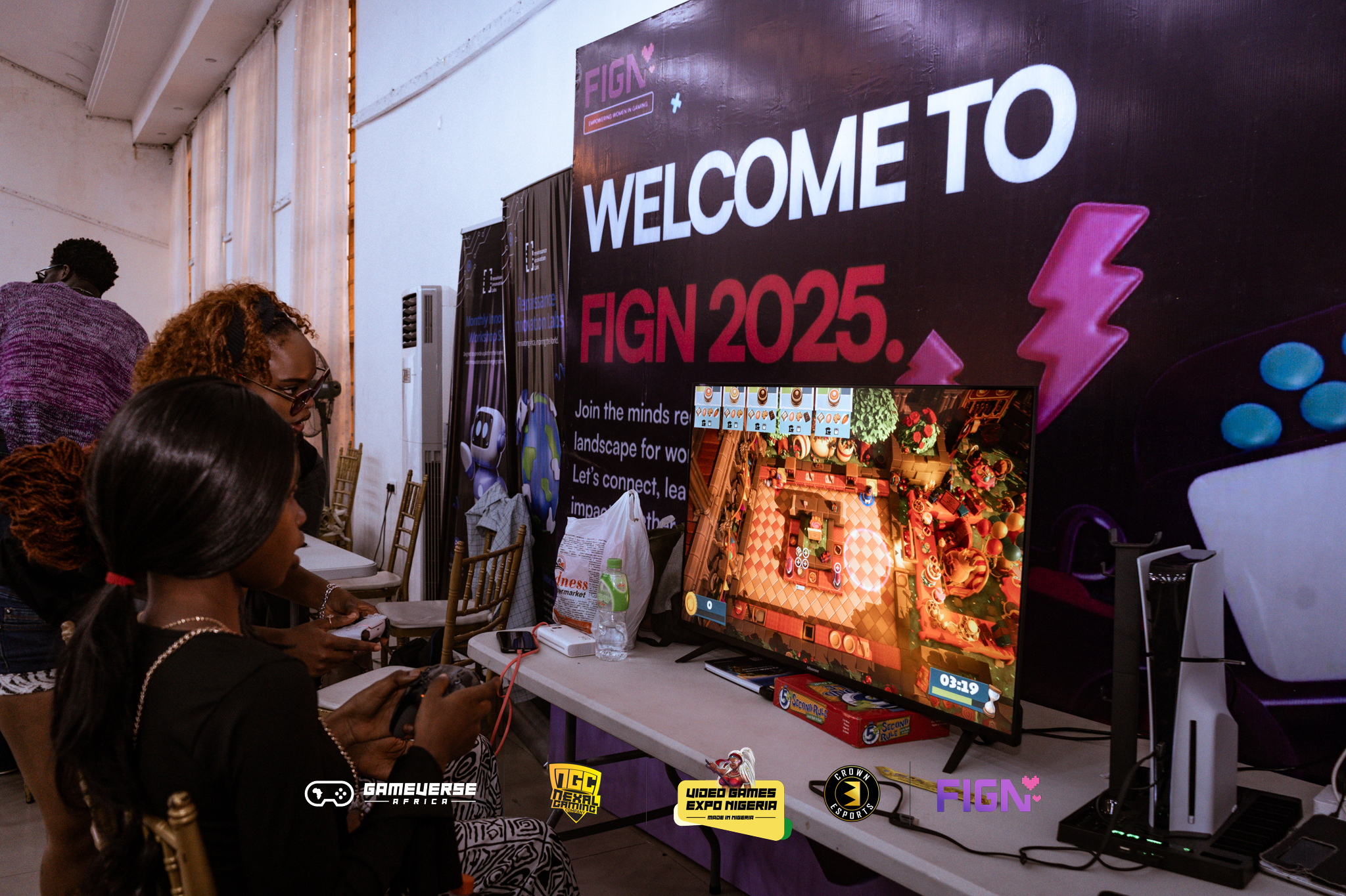 Gamers playing console games at FIGN booth